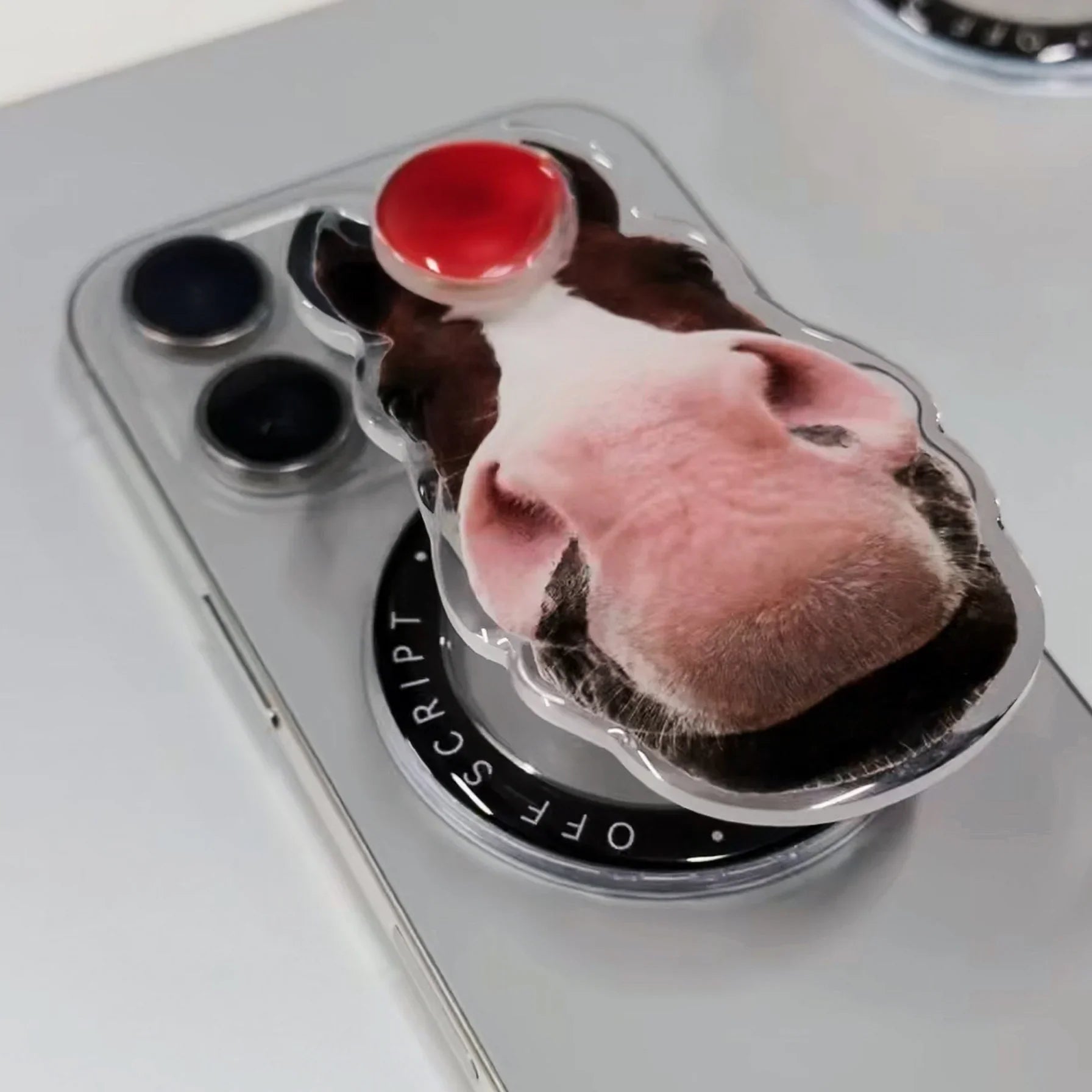 Red Apple-Horse MagSafe pop-up grip on silver iPhone, dark brown horse face with red apple on top