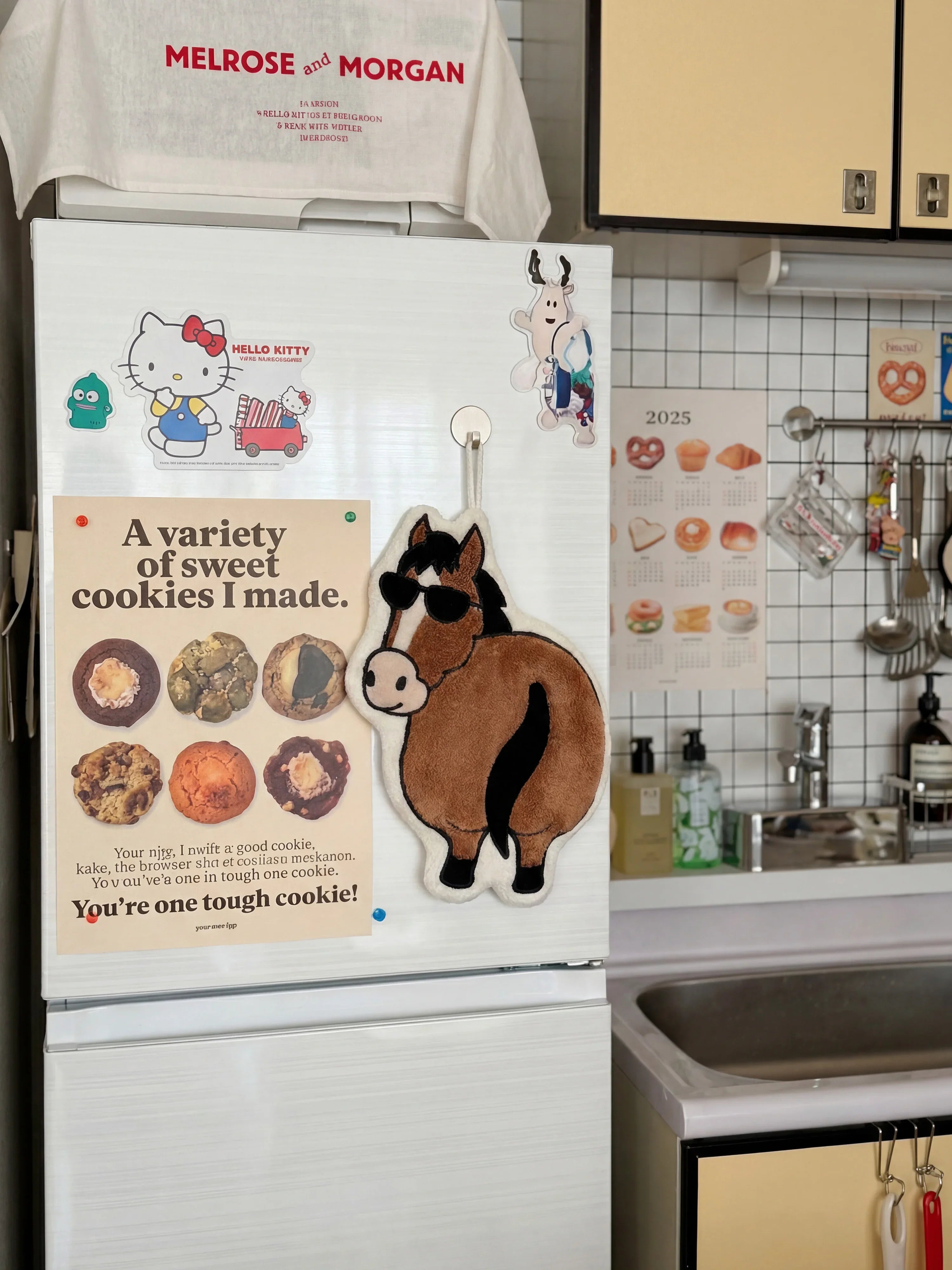 Year of the Horse Flattery cartoon towel on kitchen refrigerator beside cookie poster and cute magnets